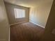 Cozy bedroom with neutral carpet, fresh paint, and a window at 4050 Pacific Harbors Dr # 217, Las Vegas, NV 89121