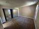 Main bedroom with neutral carpet, mirrored closet, and a window at 4050 Pacific Harbors Dr # 217, Las Vegas, NV 89121