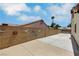 Enclosed backyard with decorative wall art and large concrete patio; perfect for low-maintenance outdoor enjoyment at 4128 Tarkin Ave, Las Vegas, NV 89120