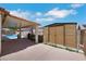 Spacious backyard showcasing a covered patio, a storage shed, and a view of the refreshing pool area at 4128 Tarkin Ave, Las Vegas, NV 89120