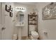 Powder room featuring a pedestal sink, decorative mirror, and stylish decor at 4128 Tarkin Ave, Las Vegas, NV 89120