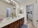 Bright bathroom featuring a double sink vanity, decorative accents, and a connecting bedroom view at 4128 Tarkin Ave, Las Vegas, NV 89120
