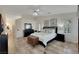 A spacious bedroom featuring a large bed, two windows, and an ornate chest at 4128 Tarkin Ave, Las Vegas, NV 89120