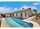 Inviting backyard pool with a covered patio and desert landscaping creates a private outdoor oasis at 4128 Tarkin Ave, Las Vegas, NV 89120