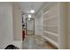 A walk in closet featuring built in shelving, a mirror, and tiled flooring at 4128 Tarkin Ave, Las Vegas, NV 89120