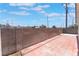 Private backyard featuring a brick-paved patio, enclosed by block walls, and topped by clear blue sky with scattered clouds at 4149 Compass Rose Way, Las Vegas, NV 89108
