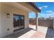 Outdoor patio with stucco wall and sliding glass door is ready for relaxing and entertaining at 4149 Compass Rose Way, Las Vegas, NV 89108
