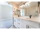 Bathroom featuring dual sinks, modern fixtures, and bright lighting at 4149 Compass Rose Way, Las Vegas, NV 89108