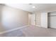 Neutral bedroom featuring plush carpeting and an ensuite bathroom with modern fixtures at 4149 Compass Rose Way, Las Vegas, NV 89108