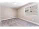 A bright, empty bedroom is carpeted and illuminated by a window showcasing the exterior at 4149 Compass Rose Way, Las Vegas, NV 89108