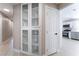 Bright hallway featuring a display cabinet with glass doors and a neutral color palette at 4149 Compass Rose Way, Las Vegas, NV 89108