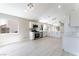 Open-concept kitchen with stainless steel appliances, white cabinets, and wood-look floors at 4149 Compass Rose Way, Las Vegas, NV 89108