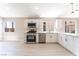 White kitchen with stainless steel appliances, plenty of cabinet space, and natural light at 4149 Compass Rose Way, Las Vegas, NV 89108