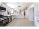 Spacious kitchen with white cabinetry, stainless appliances, and wood-look flooring at 4149 Compass Rose Way, Las Vegas, NV 89108