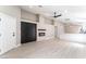 Bright living room with modern fireplace, sleek ceiling fan, and durable wood-look floors at 4149 Compass Rose Way, Las Vegas, NV 89108
