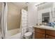 Well-lit bathroom featuring a shower-tub combo, granite countertop vanity and floral shower curtain at 4200 S Valley View Blvd # 1074, Las Vegas, NV 89103
