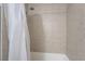 Shower tub combination with a shower curtain and neutral tiling at 4200 S Valley View Blvd # 1074, Las Vegas, NV 89103