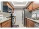 Efficient kitchen with stainless steel appliances, granite counters, and a convenient microwave at 4200 S Valley View Blvd # 1074, Las Vegas, NV 89103