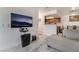 Inviting living room with a large flat-screen TV, cozy sofa, and view of the kitchen and dining area at 4200 S Valley View Blvd # 1074, Las Vegas, NV 89103