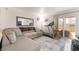 Relaxing living room with a sofa, treadmill, and sliding glass door to a balcony at 4200 S Valley View Blvd # 1074, Las Vegas, NV 89103