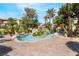 Relaxing pool area featuring a unique rock waterfall, palm trees, and comfortable lounge seating at 4200 S Valley View Blvd # 1074, Las Vegas, NV 89103