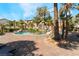 Relaxing pool area featuring a unique rock waterfall, palm trees, and comfortable lounge seating at 4200 S Valley View Blvd # 1074, Las Vegas, NV 89103