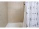 Tiled shower and tub combination with a floral curtain and silver shower head at 4200 S Valley View Blvd # 1074, Las Vegas, NV 89103