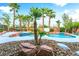 Palm trees and rock features surround the private pool and spa, perfect for outdoor enjoyment at 4200 Scott Peak Ct, Las Vegas, NV 89129