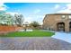 Fenced backyard featuring a grassy lawn, brick patio, and a basketball court at 4200 Scott Peak Ct, Las Vegas, NV 89129