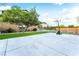 A spacious concrete backyard featuring a small grassy lawn and basketball court at 4200 Scott Peak Ct, Las Vegas, NV 89129