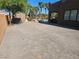 Spacious backyard with brick pavers, shed, and a partial view of the in-ground pool at 4200 Scott Peak Ct, Las Vegas, NV 89129