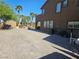 Wide backyard space with brick pavers, shed, and mature palm trees surrounding the in-ground pool at 4200 Scott Peak Ct, Las Vegas, NV 89129
