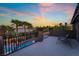 Balcony view features wrought iron, seating and a view of pool and palms at sunset at 4200 Scott Peak Ct, Las Vegas, NV 89129