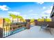 Relaxing balcony overlooking a beautiful pool area and lush landscaping with palm trees at 4200 Scott Peak Ct, Las Vegas, NV 89129