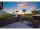 Balcony with wrought iron railing overlooking the pool and palm trees with mountain views at 4200 Scott Peak Ct, Las Vegas, NV 89129