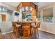 Inviting bar area with wooden bar, comfortable seating, and mirrored backdrop at 4200 Scott Peak Ct, Las Vegas, NV 89129