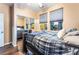 Cozy bedroom featuring a mirrored closet and a window view of the landscaped backyard at 4200 Scott Peak Ct, Las Vegas, NV 89129