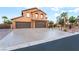Charming two-story home with a three-car garage and desert landscaping in the front yard at 4200 Scott Peak Ct, Las Vegas, NV 89129