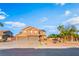 Charming two-story home with a three-car garage and desert landscaping with palm trees at 4200 Scott Peak Ct, Las Vegas, NV 89129