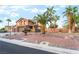 Charming two-story home with desert landscaping and a large palm tree in the front yard at 4200 Scott Peak Ct, Las Vegas, NV 89129