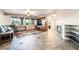Spacious living room with tiled floors, large windows, and a cozy fireplace with built-in media center at 4200 Scott Peak Ct, Las Vegas, NV 89129