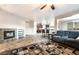 Open-concept living space with a fireplace, couch and kitchen with breakfast bar at 4200 Scott Peak Ct, Las Vegas, NV 89129