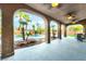 Covered patio with elegant arches overlooks a stunning pool with tropical landscaping at 4200 Scott Peak Ct, Las Vegas, NV 89129