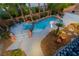 Aerial view showcases a pool, spa, lush landscape, and a cozy outdoor seating area at 4200 Scott Peak Ct, Las Vegas, NV 89129