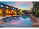 Backyard pool featuring rock landscaping, palm trees, and an attached jacuzzi at 4200 Scott Peak Ct, Las Vegas, NV 89129