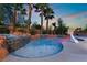 Inviting in-ground pool with integrated spa, rock accents and a basketball hoop for outdoor fun at 4200 Scott Peak Ct, Las Vegas, NV 89129