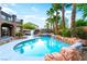 Relax and unwind in the pool and hot tub, surrounded by towering palm trees at 4200 Scott Peak Ct, Las Vegas, NV 89129