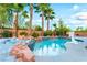 Beautiful pool with rock features and lush tropical landscaping offers a private oasis at 4200 Scott Peak Ct, Las Vegas, NV 89129