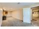 Finished basement area with neutral carpet and open access to garage at 440 N Lisbon St, Henderson, NV 89015