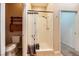 Bathroom with tiled shower, toilet, and a small built-in shelf at 440 N Lisbon St, Henderson, NV 89015